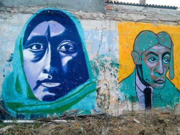 Barcelona Street Photography, blue face woman, green headscarf, street art mural