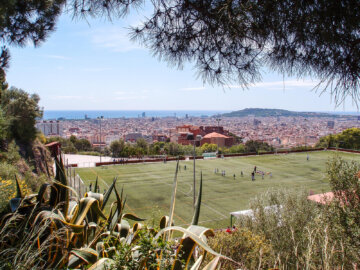 Barcelona Street Photography city panorama, green football fileld, park Montjuic mountain, passeig auigues