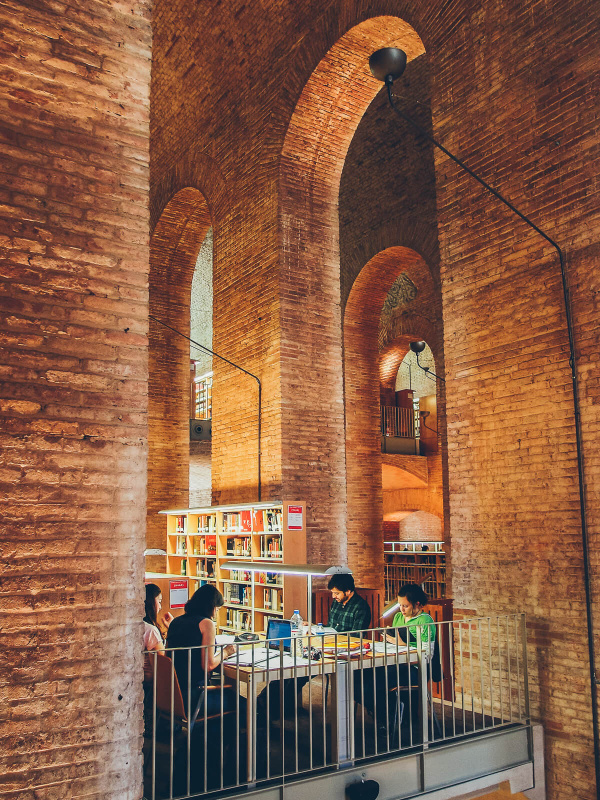 Barcelona, high brick walls, les aigues library, students working, water reservoir