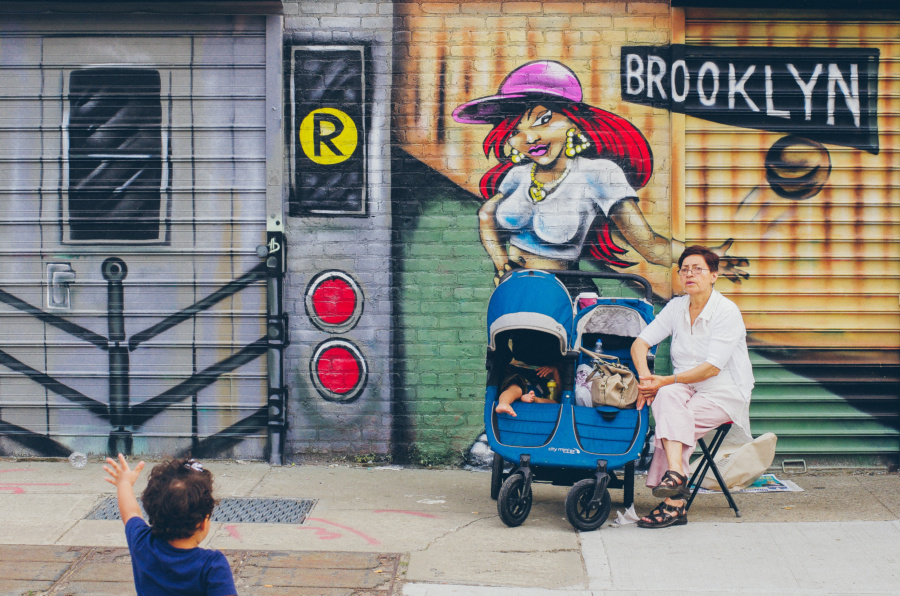 Sitting under a Brooklyn Mural hand
