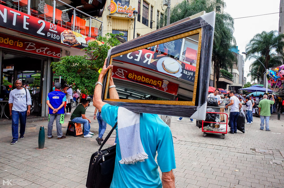 Man carrying a mirror on his shoulder